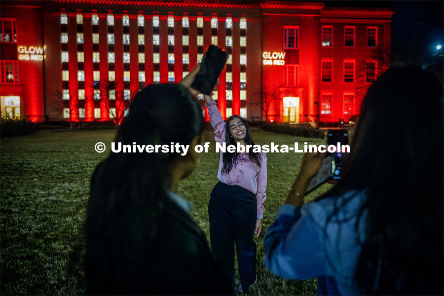 Charitha Manduri and friends take photos outside Love Library during the Glow Big Red event. February 14, 2024. Photo by Kristen Labadie / University Communication.